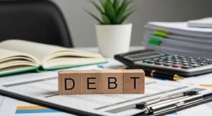vecteezy wooden blocks spelling debt on financial reports in a bright